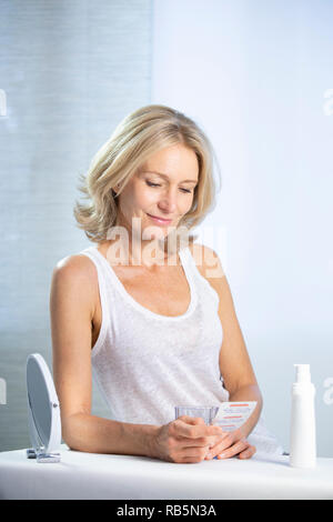 A menopausal woman using HRT. Stock Photo