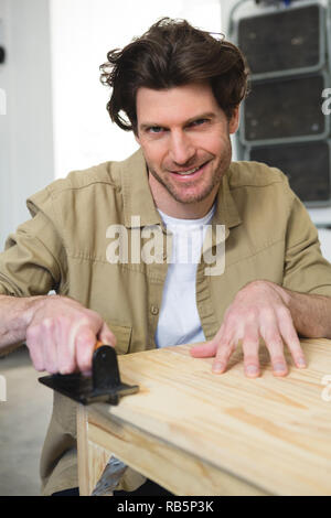 Male carpenter working on wood Stock Photo