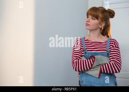 Female carpenter standing with arms crossed Stock Photo