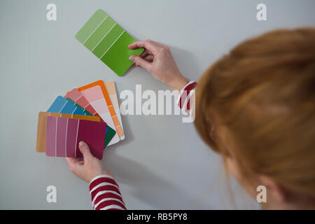 Female painter matching color shades Stock Photo