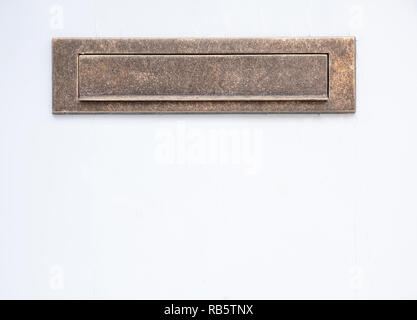 Old bronze mailbox. Brass vintage mail letter box on white color wall background. Closeup view with details Stock Photo