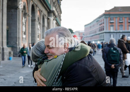 Naples, Italy - December 16th 2018: Piazza del Plebiscito, a hug between two people on the street in a sign of solidarity and peace. We are in the Chr Stock Photo