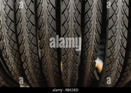 New bicycle tires hanging in a rack of a bicycle workshop Stock Photo