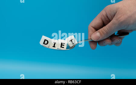 A spoon full of sugar cubes form the word "DIET" Stock Photo