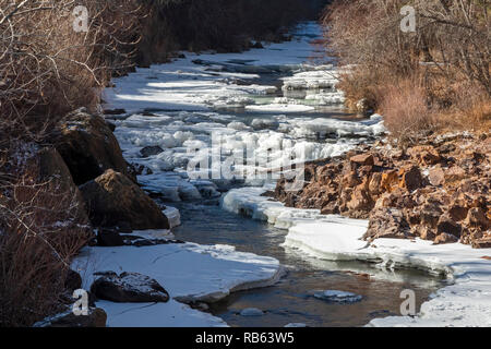 Golden Colorado - Clear Creek, partially frozen in winter. The creek flows from the Continental Divide in the Rocky Mountains through Clear Creek Cany Stock Photo