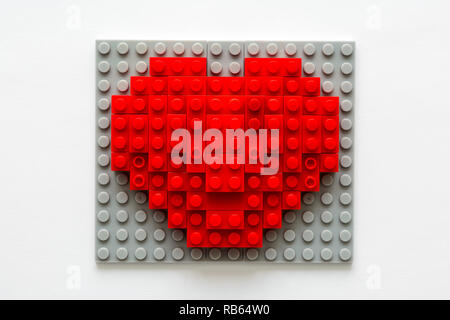 Red heart made from building blocks on gray background. Valentines day celebration and minimalist concept. Stock Photo