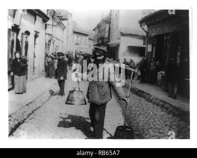 Jewish water carrier standing in a street in Vilna, Russia Stock Photo