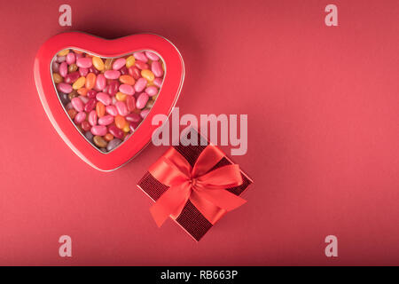 Heart-shaped box with multicolor jelly beans and red gift box Stock Photo