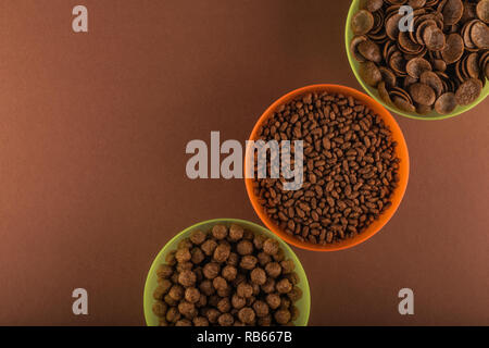 Various chocolate cornflakes in colorful bowls Stock Photo