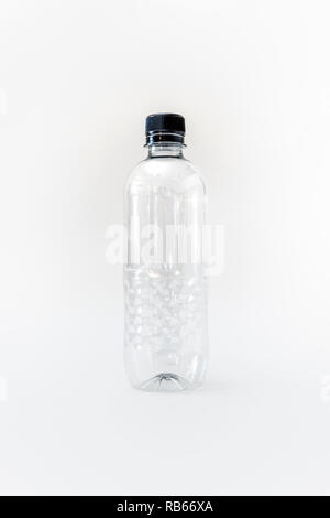 An empty generic single use plastic water bottle on a white background, no label Stock Photo