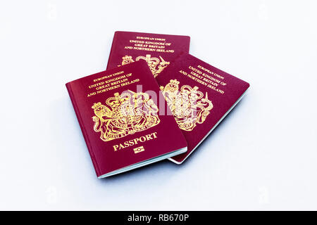 A group of three United Kingdom EU passports isolated on a white background Stock Photo