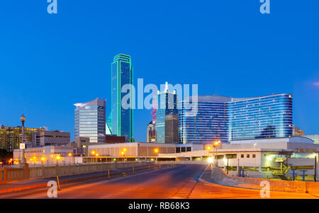 Downtown Dallas skyline at night with illuminated glass buildings seen from Houston Street Stock Photo