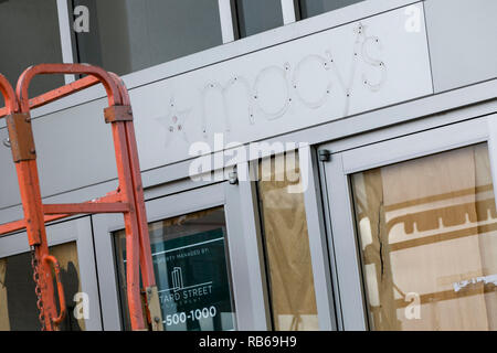 The outline of a logo sign outside of a closed Macy's retail store in Muncy, Pennsylvania, on December 30, 2018. Stock Photo