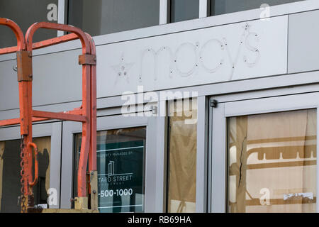 The outline of a logo sign outside of a closed Macy's retail store in Muncy, Pennsylvania, on December 30, 2018. Stock Photo