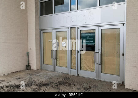 The outline of a logo sign outside of a closed Macy's retail store in Muncy, Pennsylvania, on December 30, 2018. Stock Photo