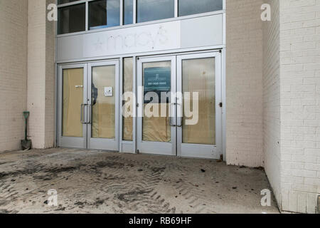 The outline of a logo sign outside of a closed Macy's retail store in Muncy, Pennsylvania, on December 30, 2018. Stock Photo