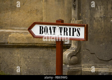 PRAGUE, CZECH REPUBLIC - JULY 2018: Close up of a tourist information sign pointing the way for boat trips on the River Vltava in Prague. Stock Photo