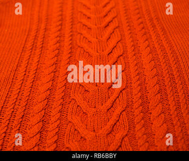 Orange Brown Terracotta Knitted pattern wool sweater texture close up. Handmade orange brown knitting wool texture background Stock Photo