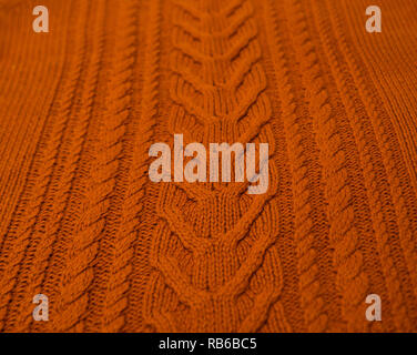 Orange Brown Terracotta Knitted pattern wool sweater texture close up. Handmade orange brown knitting wool texture background Stock Photo