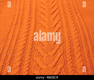 Orange Brown Terracotta Knitted pattern wool sweater texture close up. Handmade orange brown knitting wool texture background Stock Photo