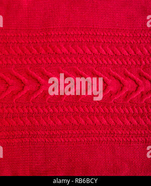 Red Knitted pattern wool sweater texture close up. Handmade red knitting wool texture background Stock Photo