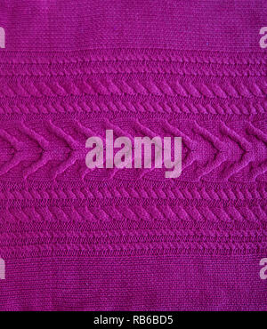 Pink purple magenta Knitted pattern wool sweater texture close up. Handmade pink purple magenta knitting wool texture background Stock Photo