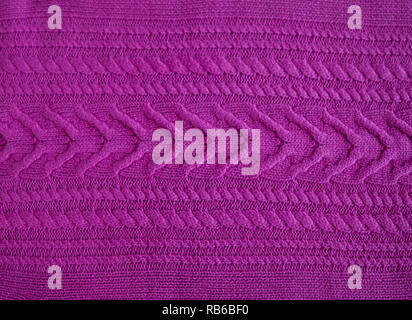 Pink purple magenta Knitted pattern wool sweater texture close up. Handmade pink purple magenta knitting wool texture background Stock Photo