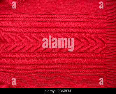 Red Knitted pattern wool sweater texture close up. Handmade red knitting wool texture background Stock Photo