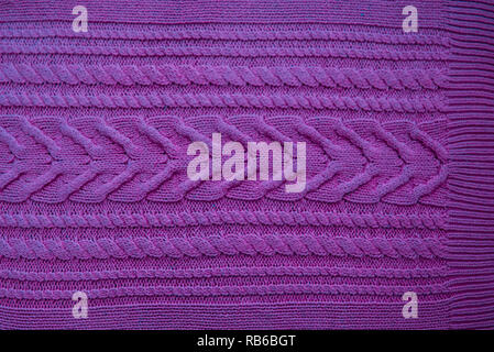 Pink purple magenta Knitted pattern wool sweater texture close up. Handmade pink purple magenta knitting wool texture background Stock Photo