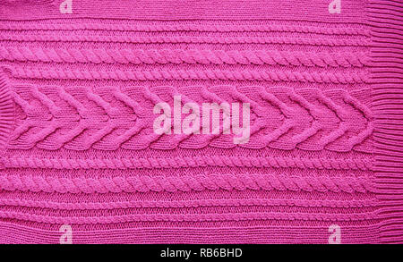 Pink purple magenta Knitted pattern wool sweater texture close up. Handmade pink purple magenta knitting wool texture background Stock Photo