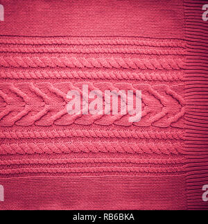Pink Blush Terracotta Knitted pattern wool sweater texture close up. Handmade red knitting wool texture background Stock Photo