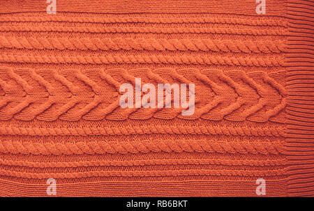 Orange Brown Terracotta Knitted pattern wool sweater texture close up. Handmade orange brown knitting wool texture background Stock Photo