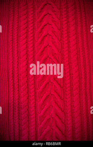 Red Knitted pattern wool sweater texture close up. Handmade red knitting wool texture background Stock Photo