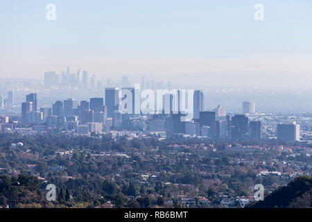 Smoggy morning cityscape view towards Century City and downtown Los Angeles from hiking trail in the Santa Monica Mountains. Stock Photo