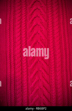 Red Knitted pattern wool sweater texture close up. Handmade red knitting wool texture background Stock Photo