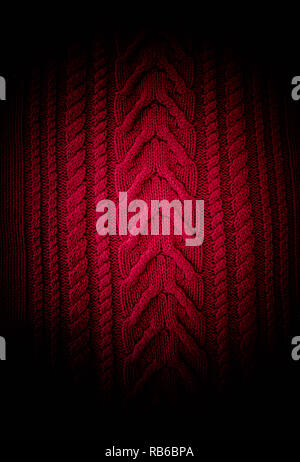 Red Knitted pattern wool sweater texture close up. Handmade red knitting wool texture background Stock Photo