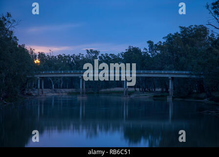 The sun just starting to rise over the Murray River, rural Australia, with cool tomes and reflections in the river Stock Photo