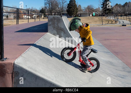 Denver, Colorado - Adam Hjermstad Jr., 4, rides his balance bike in a skatepark. Stock Photo