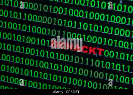 04 January 2019, Mecklenburg-Western Pomerania, Schwerin: The word "hacked" can be seen between the binary code on a laptop monitor (ILLUSTRATION/ posed photo). Photo: Jens Büttner/dpa-Zentralbild/ZB Stock Photo
