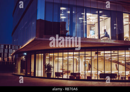 A man studying late at night in the Blavatnik School of Government, Walton street, Jericho, Oxford. Stock Photo
