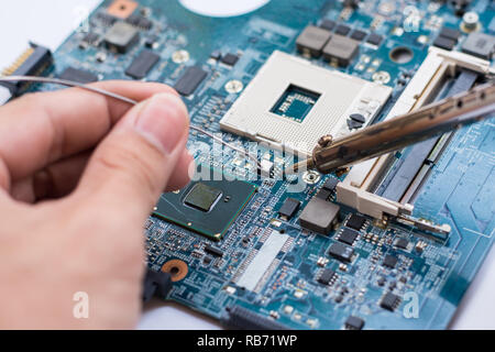 Repair of electronic devices, tin soldering parts Stock Photo