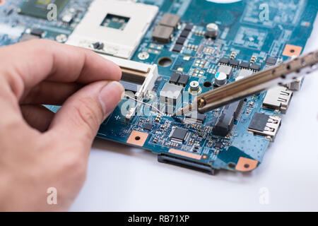 Repair of electronic devices, tin soldering parts Stock Photo