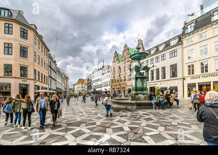 Tourists wander the Stroget shopping district near the Stork Fountain, the longest pedestrian street in the world, in Copenhagen, Denmark. Stock Photo