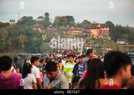 Kanchanaburi, Thailand - December 30, 2018: Tourists crowded on Saphan Mon Wooden Bridge (Mon Bridge), longest wooden bridge of Thailand during New Ye Stock Photo