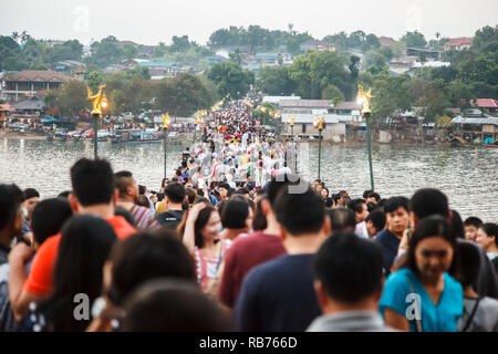 Kanchanaburi, Thailand - December 30, 2018: Tourists crowded on Saphan Mon Wooden Bridge (Mon Bridge), longest wooden bridge of Thailand during New Ye Stock Photo