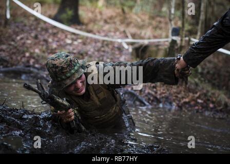 https://l450v.alamy.com/450v/rb77hy/us-marine-corps-lance-cpl-samuel-roque-a-production-specialist-with-the-combat-camera-section-marine-corps-combat-service-support-schools-gets-help-climbing-out-of-a-mud-pit-while-conducting-an-obstacle-course-on-camp-johnson-nc-december-12-2016-the-combat-camera-marines-ran-through-multiple-obstacle-courses-as-part-of-section-physical-training-in-order-to-maintain-a-state-of-constant-readiness-and-strengthen-unit-cohesion-rb77hy.jpg