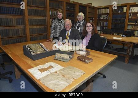 NEWPORT, R.I. (Dec. 1, 2016) Dara Baker (front right), head archivist for the Naval Historical Collection (NHC) at U.S. Naval War College (NWC) in Newport, Rhode Island accepts a donation from Duncan and Jeanne Ingraham (back left), MaryAnn (Ingraham) Brenner (back right), and Anne Hopkins (not pictured), family of U.S. Navy and Confederate navy officer Duncan Nathaniel Ingraham. The Ingraham family donated papers to NWC’s NHC that include three previously unknown manuscripts of historical significance, including a manuscript from Ingraham detailing the cruise of the U.S. Civil War Confederate Stock Photo