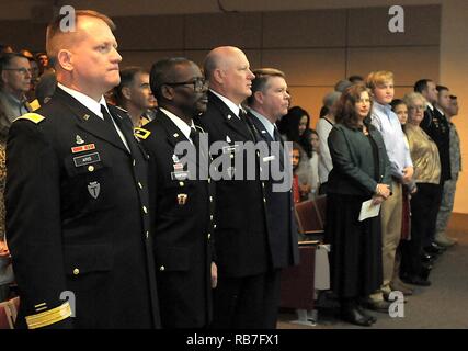 Col. Charles 'Chuck' Aris, 36th Infantry Division Assistant Division Commander of Support, Maj. Gen. Leslter Simpson, 36th Infantry Division Commanding General, Maj. General James K. 'Red' Brown, U.S. Forces Command Deputy Commanding General - Reserve Component, Maj. Gen. Jogn Nichols, Texas Military Department Adjutant General, stand for the National Anthem during the promotion of Aris from Col. to Brig. Gen. on Sunday, Dec. 4, 2016, at Camp Mabry, Austin, Texas. He is joined by family, friends and colleagues to celebrate his promotion at a ceremony and following reception at the Texas Milita Stock Photo