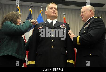 Maj. Gen. James K. 'Red' Brown, U.S. Forces Command Deputy Commanding General - Reserve Component and former 36th Infantry Division Commanding General, and Amy Aris promote Charles 'Chuck' Aris to Brig. Gen. on Sunday, Dec. 4, 2016, at Camp Mabry, Austin, Texas. He is joined by family, friends and colleagues to celebrate his promotion at a ceremony and following reception at the Texas Military Forces Museum. Aris has been selected to deploy to Afghanistan as the Commander of the Train, Advise, Assist Command -- South during the 36th Infantry Division's second command rotation in support of Ope Stock Photo