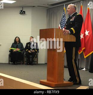 Maj. Gen. James K. 'Red' Brown, U.S. Forces Command Deputy Commanding General - Reserve Component of former 36th Infantry Division Commanding General, provides a congratulations speech to Brig. Gen. Charles 'Chuck' Aris, 36th Inf. Div. Assistant Division Commander of Support and his wife, Amy, during a promotion ceremony on Sunday, Dec. 4, 2016, at Camp Mabry, Austin, Texas. He is joined by family, friends and colleagues to celebrate his promotion at a ceremony and following reception at the Texas Military Forces Museum. Aris has been selected to deploy to Afghanistan as the Commander of the T Stock Photo